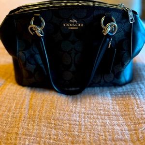 Coach purse black leather with signature C design.